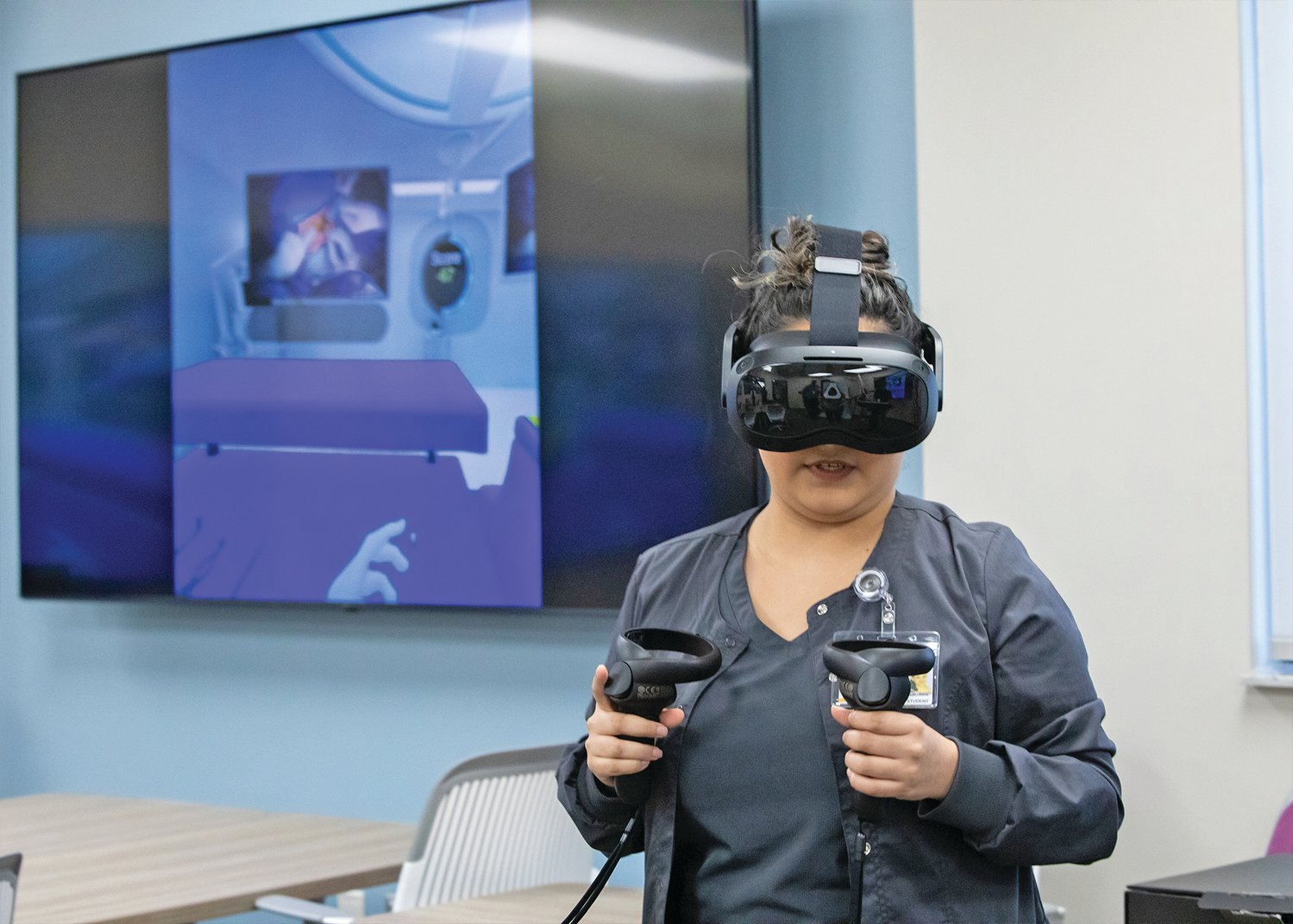 Bianca Delafuente, Surgical Services program student, demonstrates virtual reality equipment.